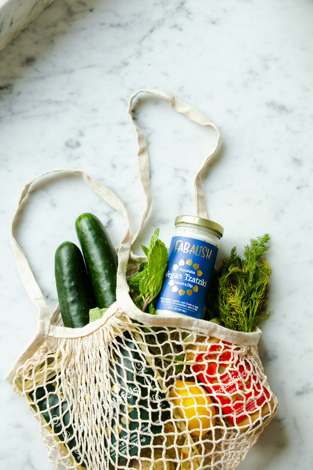 A net bag with healthy foods spilling out.
